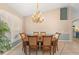 A dining room featuring a chandelier, hardwood floors, and large window that provides great natural light at 127 Mill E Run, Bradenton, FL 34212
