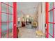 Foyer leading to a living room with tile floor, chandelier and a glimpse of the patio at 127 Mill E Run, Bradenton, FL 34212
