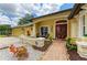 Inviting front porch with seating, decorative plants, and a red door offering a warm welcome at 127 Mill E Run, Bradenton, FL 34212