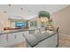 Gourmet kitchen with white cabinets, granite countertops, a large island, and open access to the breakfast nook and living room at 127 Mill E Run, Bradenton, FL 34212