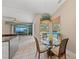 Eat-in kitchen featuring granite countertops, stainless steel appliances, and a view of the outdoor pool at 127 Mill E Run, Bradenton, FL 34212
