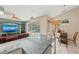 Open layout showing the kitchen with breakfast bar and stools leading to the breakfast nook with a view of the pool at 127 Mill E Run, Bradenton, FL 34212