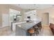 Open-concept kitchen featuring granite counters, stainless appliances, breakfast bar with seating, and stylish pendant lighting at 127 Mill E Run, Bradenton, FL 34212