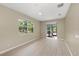 Living room with natural light, light floors, a ceiling fan, and a view of the backyard at 127 Mill E Run, Bradenton, FL 34212