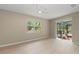 Sunlit living room with light floors, a ceiling fan, and sliding doors to the outdoor space at 127 Mill E Run, Bradenton, FL 34212