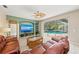 Inviting living room with built-in shelving and a view of the pool area, perfect for relaxation and entertaining at 127 Mill E Run, Bradenton, FL 34212