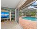 Living room with sliding doors that open to the pool and patio, extending the living space outdoors at 127 Mill E Run, Bradenton, FL 34212