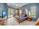 Elegant main bedroom featuring a four-poster bed and private access to the pool area at 127 Mill E Run, Bradenton, FL 34212