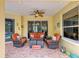 Outdoor patio with seating, ceiling fan, and tropical decor, overlooks pool at 127 Mill E Run, Bradenton, FL 34212