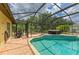 Screened-in pool and spa surrounded by a brick patio and lush landscaping at 127 Mill E Run, Bradenton, FL 34212