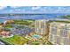Aerial view of high-rise residential buildings with community pool and manicured lawns near the water at 130 Riviera Dunes Way # 502, Palmetto, FL 34221