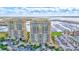 An aerial view of high-rise apartments with parking and a boat filled harbor in the background at 130 Riviera Dunes Way # 502, Palmetto, FL 34221