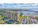 Overhead view of luxury waterfront apartments, parking, and harbor with boats in the background at 130 Riviera Dunes Way # 502, Palmetto, FL 34221