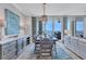 Beautiful dining room with water views, modern chandelier, and an accent rug at 130 Riviera Dunes Way # 502, Palmetto, FL 34221