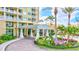 Inviting condo entrance with manicured landscaping, a porte-cochère, and elegant architectural details at 130 Riviera Dunes Way # 502, Palmetto, FL 34221