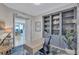 Comfortable home office with built-in bookshelves and partial views to the dining room and beyond at 130 Riviera Dunes Way # 502, Palmetto, FL 34221
