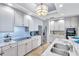 Bright kitchen featuring stainless steel appliances, counter seating, and modern lighting at 130 Riviera Dunes Way # 502, Palmetto, FL 34221