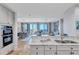 Open kitchen with granite counters, stainless appliances, and water views in the background at 130 Riviera Dunes Way # 502, Palmetto, FL 34221
