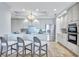 Bright kitchen featuring stainless steel appliances, counter seating, and modern lighting at 130 Riviera Dunes Way # 502, Palmetto, FL 34221