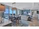 Bright living and dining area offering stunning water views, stylish seating, and elegant decor at 130 Riviera Dunes Way # 502, Palmetto, FL 34221