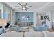 Comfortable living room with neutral tones, stylish seating, a ceiling fan, and views from the large windows at 130 Riviera Dunes Way # 502, Palmetto, FL 34221