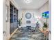 Stylish office with built-in shelves, a modern desk, and a decorative rug, creating a professional workspace at 130 Riviera Dunes Way # 502, Palmetto, FL 34221