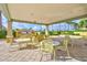Outdoor grill area with plenty of seating for entertaining, palm trees in the background at 130 Riviera Dunes Way # 502, Palmetto, FL 34221