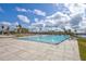 Large pool with palm trees and lounge chairs on a sunny day at 130 Riviera Dunes Way # 502, Palmetto, FL 34221