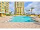 Large community pool with ample deck space, lounge chairs and palm trees at 130 Riviera Dunes Way # 502, Palmetto, FL 34221