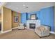 Comfortable sitting area with a fireplace and stylish armchairs at 130 Riviera Dunes Way # 502, Palmetto, FL 34221