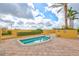 A spa on a sunny day, surrounded by lush landscaping and palm trees at 130 Riviera Dunes Way # 502, Palmetto, FL 34221