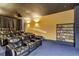 Home theater room with comfortable seating, projector, and DVD collection on shelves at 130 Riviera Dunes Way # 502, Palmetto, FL 34221