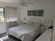 Bright bedroom with wicker furniture, neutral colors, and natural light from the window at 1414 58Th W St # 1414, Bradenton, FL 34209