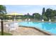 Sparkling community pool with comfortable lounge chairs and umbrellas, ideal for enjoying sunny days at 1414 58Th W St # 1414, Bradenton, FL 34209