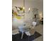 Dining room showcasing a glass table, wicker base, chairs, and modern light fixture at 1414 58Th W St # 1414, Bradenton, FL 34209