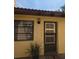 Welcoming entrance featuring a storm door, window and house number 1414 at 1414 58Th W St # 1414, Bradenton, FL 34209