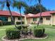 Charming villa with well-maintained landscaping, mature palms, and red tiled roof at 1414 58Th W St # 1414, Bradenton, FL 34209