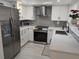 Updated kitchen featuring stainless steel appliances, white cabinetry, and modern countertops at 1414 58Th W St # 1414, Bradenton, FL 34209