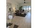 Comfortable living room with modern décor, sliding glass doors, and stylish furnishings at 1414 58Th W St # 1414, Bradenton, FL 34209