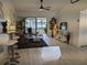 Open-concept living room with light wood flooring, ceiling fan, and sliding doors at 1414 58Th W St # 1414, Bradenton, FL 34209