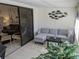 Enclosed sunroom featuring a neutral sofa set, tile floors, and view of the living room at 1414 58Th W St # 1414, Bradenton, FL 34209