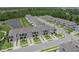 Aerial view of newly constructed townhomes with private driveways, surrounded by lush landscaping and a serene pond at 15051 Ginetti St, Nokomis, FL 34275