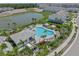 Aerial view showcases the community pool, cabana, and scenic pond at 15051 Ginetti St, Nokomis, FL 34275
