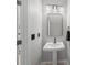 Elegant powder room features a pedestal sink, modern lighting, and stylish fixtures at 15051 Ginetti St, Nokomis, FL 34275