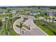 Aerial view of the community entrance and pool with lush landscaping at 15051 Ginetti St, Nokomis, FL 34275
