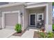 Exterior of a townhome, with a single car garage and a cozy porch seating area at 15051 Ginetti St, Nokomis, FL 34275