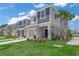 Charming two-story townhome featuring a well-manicured lawn, landscaping, and a one-car garage at 15051 Ginetti St, Nokomis, FL 34275