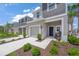 Inviting townhome showcasing a one-car garage, walkway, and pleasant landscaping at 15051 Ginetti St, Nokomis, FL 34275