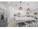 Bright kitchen features stainless steel appliances, a large island with seating, and modern pendant lighting at 15051 Ginetti St, Nokomis, FL 34275