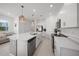 Spacious kitchen has stainless appliances, white cabinetry, a center island, and tile flooring at 15051 Ginetti St, Nokomis, FL 34275